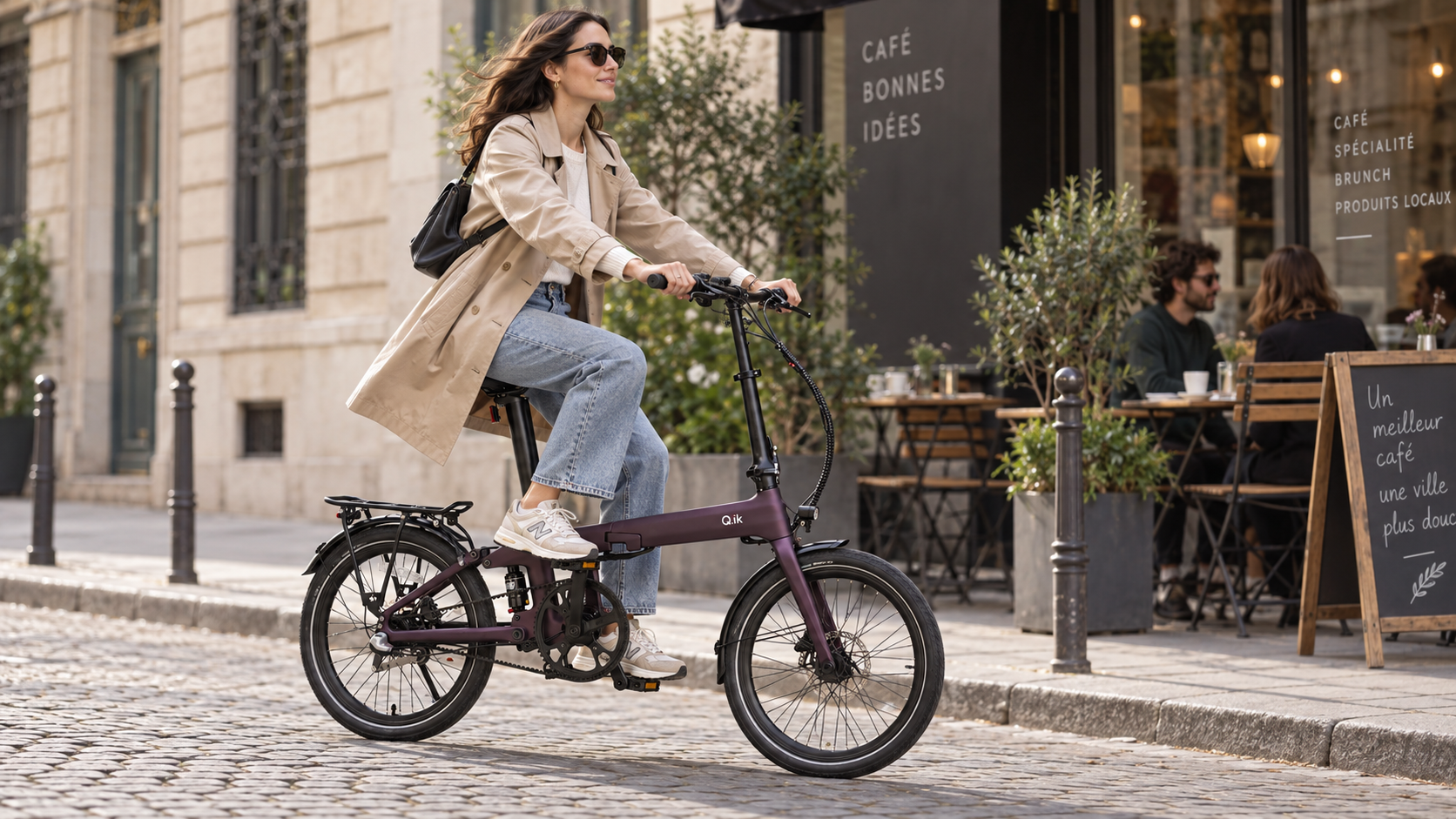 Q.ik folding electric bicycle outside a city cafe