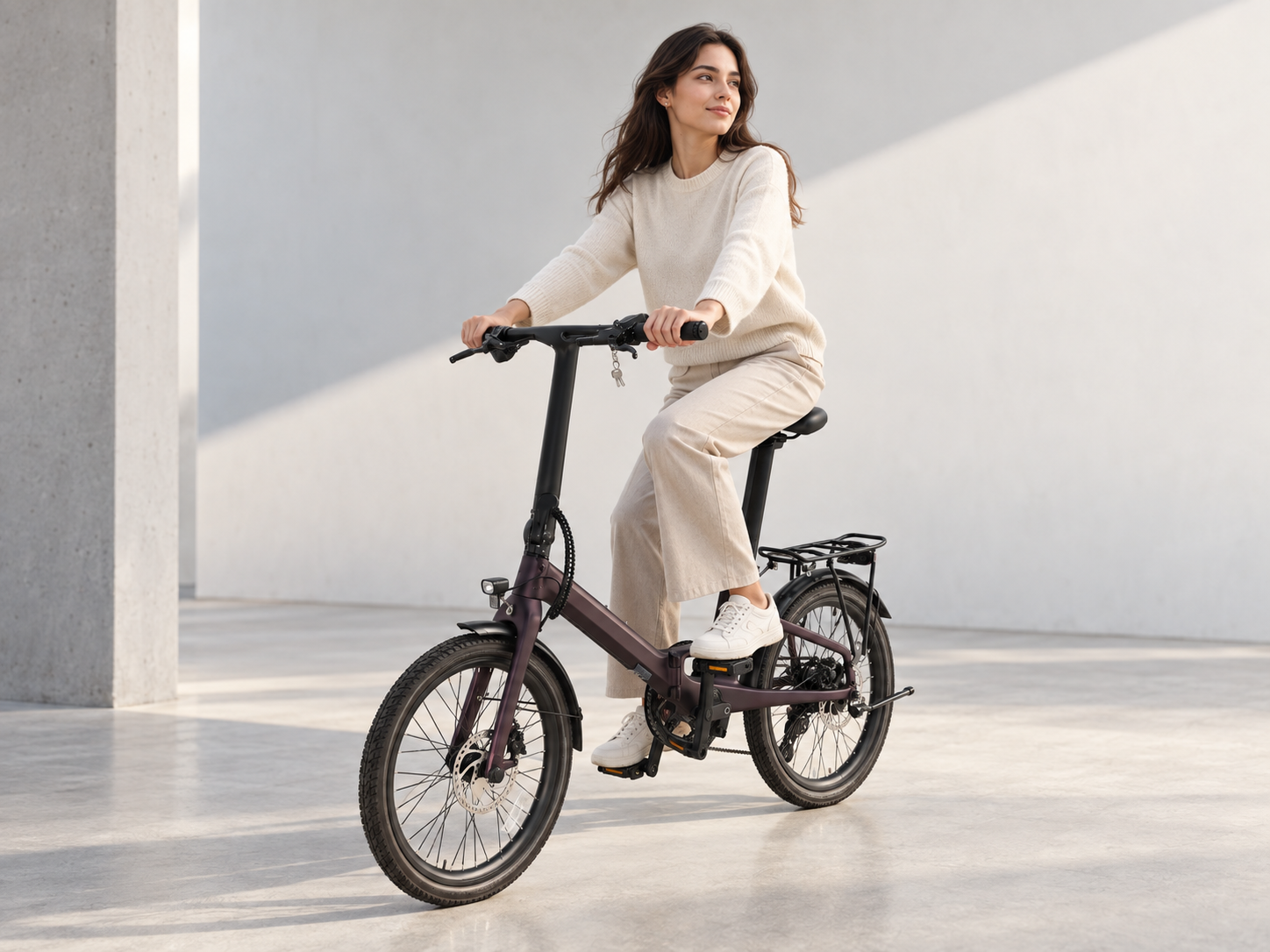 Rider on a Q.ik folding e-bike in a city setting